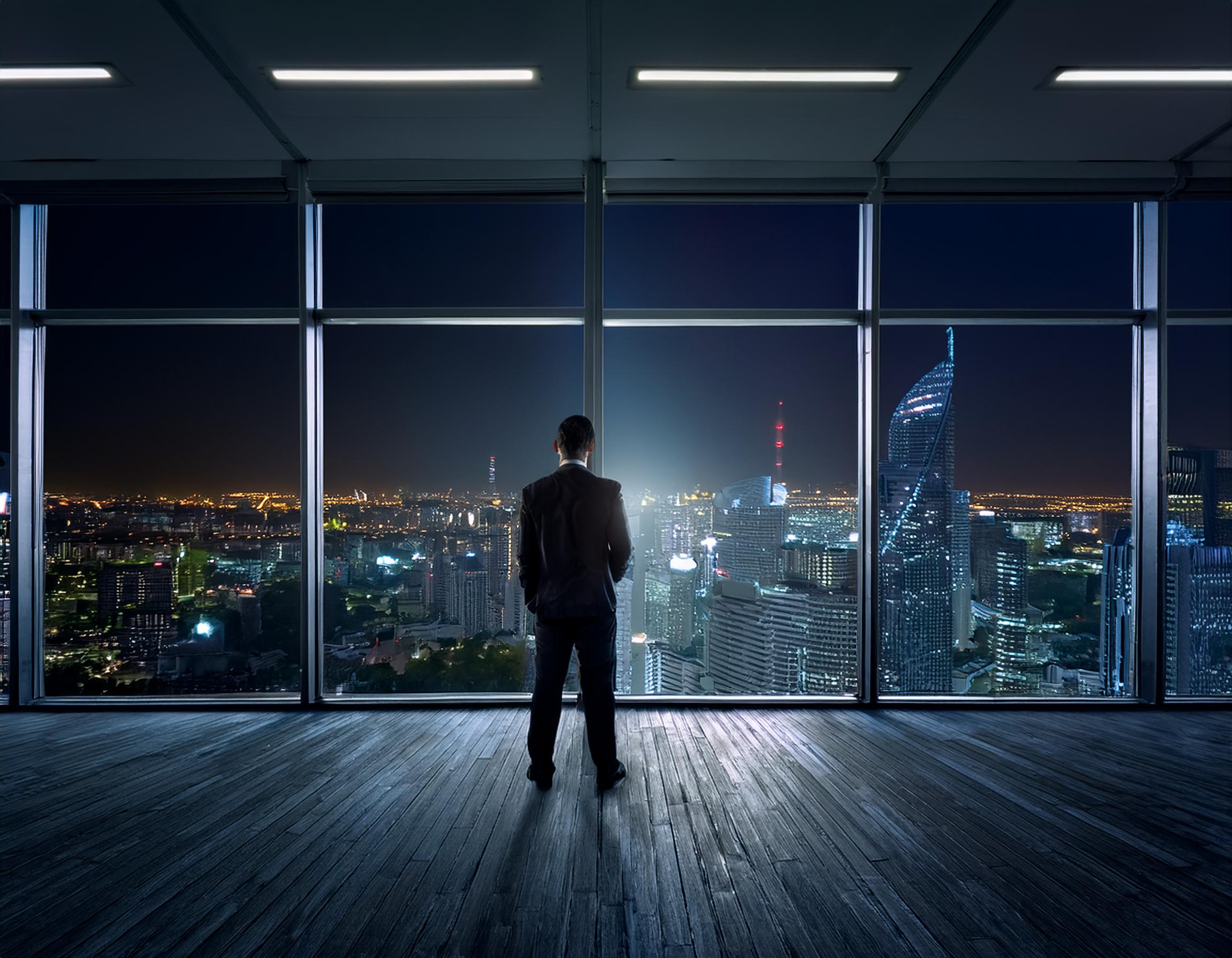 https://imperialresearchsolutions.com/wp-content/uploads/2024/09/Firefly-A-businessman-looking-out-the-window-of-an-office-at-night-with-black-walls-inside-the-offi.jpg